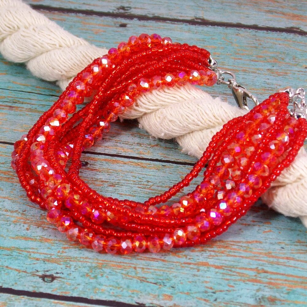 Red multi strand glass and seed bead bracelet made with 9 strands of red beads